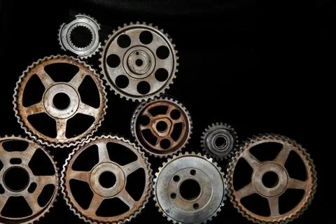 Interlocking industrial  cogwheels top view on black background Stock Photos