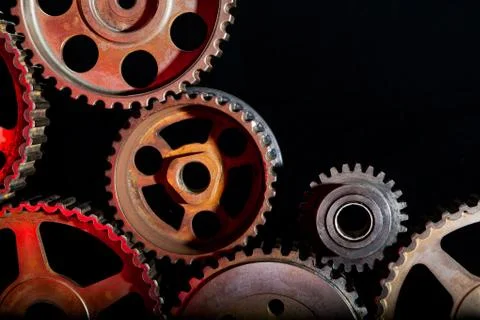 Interlocking industrial  cogwheels top view on black background Stock Photos