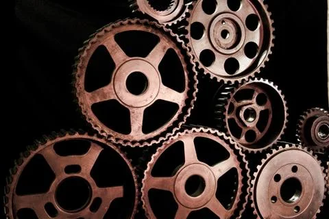 Interlocking industrial  cogwheels top view on black background Stock Photos