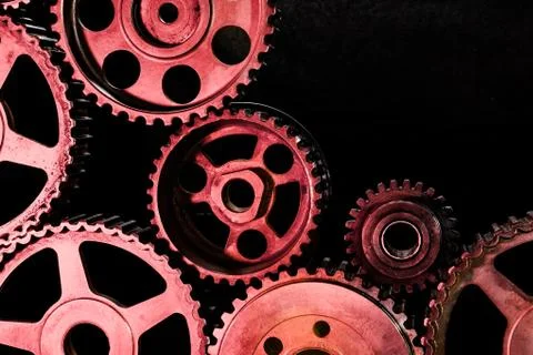 Interlocking industrial  cogwheels top view on black background Stock Photos