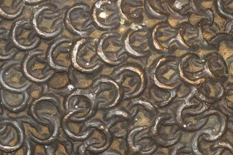 Interlocking metal chainmail rings texture with bronze and rust patina Stock Photos