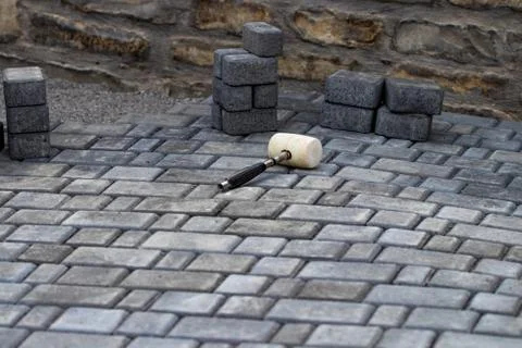 Interlocking paving with gray and white concrete blocks; Concrete products; C Stock Photos
