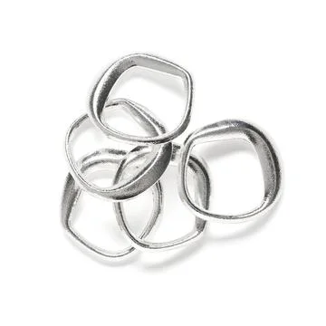 Interlocking silver metal rings abstract art piece, modern metallic sculpture Stock Photos