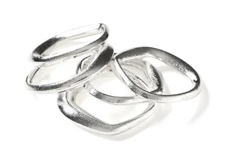 Interlocking silver metal rings abstract design, modern jewelry component, in Stock Photos