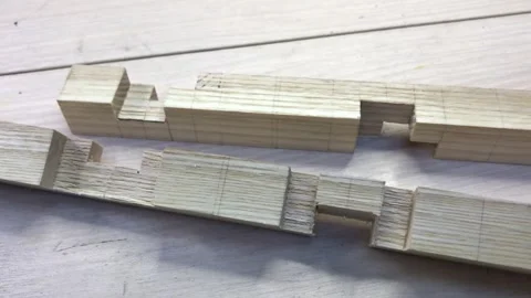 Interlocking two precisely cut wooden blocks together with hands Stock Footage 317598673