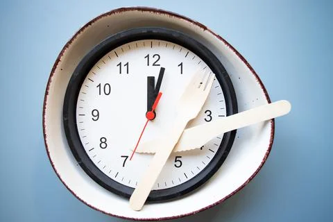 Intermittent fasting concept empty plate and clock 写真素材