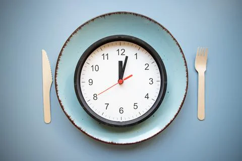 Intermittent fasting concept empty plate and clock 写真素材