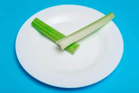 Intermittent fasting, diet concept. An empty plate as a dial and pods of a se Stock Photos