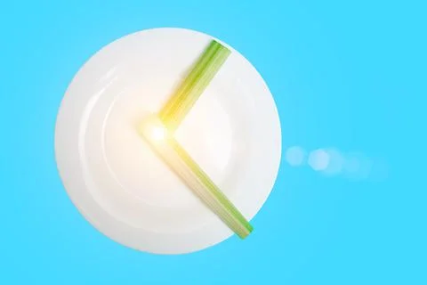 Intermittent fasting, diet concept. An empty plate as a dial and pods of a se 스톡 사진