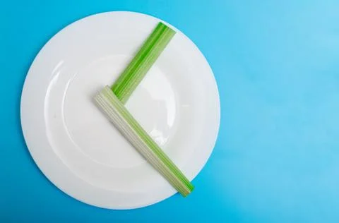 Intermittent fasting, diet concept. An empty plate as a dial and pods of a se 写真素材