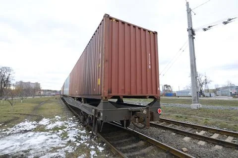 Intermodal freight container on railway flatcar wagon at cargo station. Kyi.. Stock Photos