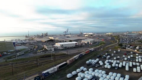 Intermodal Freight Train Passing Port Warehouses and Storage Yards Stock Footage 337651572
