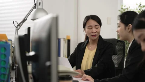 Intern learning new skills from her mentor coach Stock Footage 228366247