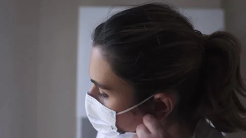 Intern-practitioner removing mask from face in hospital ward Stock Footage 248981526