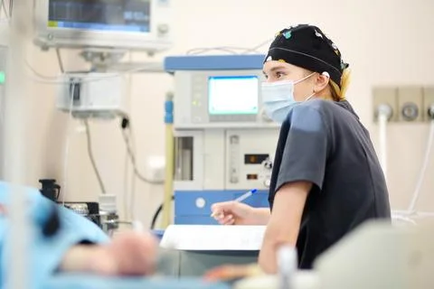 Intern surgeon records the progress of the operating room in a journal. Wea.. Stock Photos