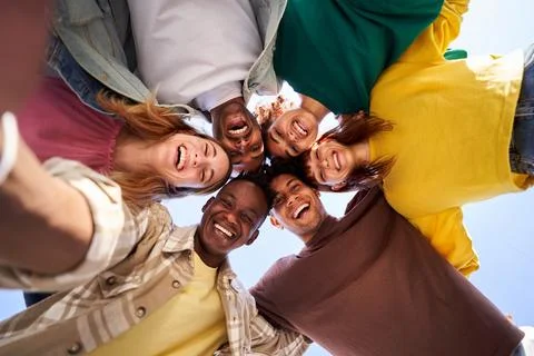 Internacional Erasmus students looking at camera cheerfully embracing each other Stock Photos