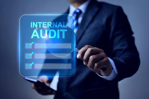 Internal audit concept with auditor using magnifying glass to find and search Fotos de archivo