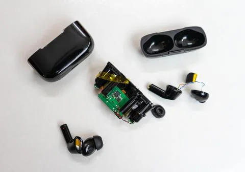Internal Components of Broken Bluetooth Earphones and Case Spread Out Stock Photos