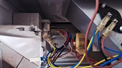 Internal electrical wiring connections inside a white household kitchen Stock Photos