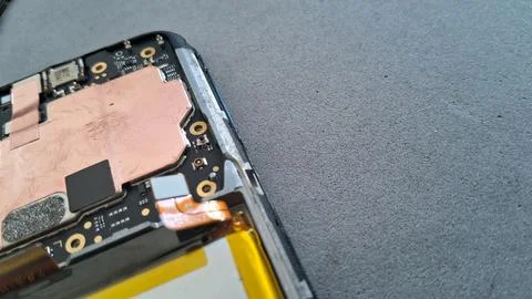 Internal electronic components exposed inside a damaged modern smartphone mobile Stock Photos