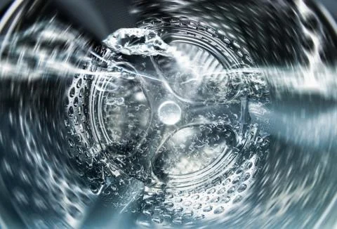 Internal view of an empty washing machine drum during wash Stock Photos