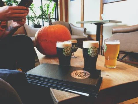 International beer day, Glasses of light and dark beer on a pub background. Stock Photos