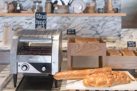 International buffet with assorted bread and toast line and toaster on table  Stock Photos