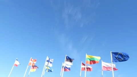 International countries flags blowing in the wind - blue sky background Stock Footage 138615210