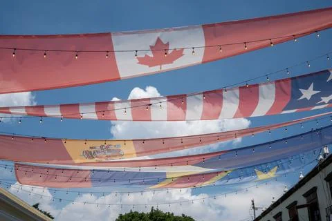 International flags and string lights decorating a vibrant street in Tlaquepaque Stock Photos