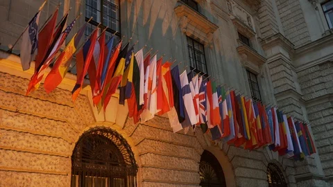 International flags waving on front of the building in the evening time. Stock Footage 107445217