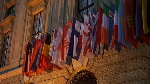 International flags waving on front of the building in the evening time. Stock Footage 107445335
