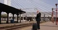 International Railway Businessman Keeping Newspaper Waiting and Talking Mobile 4k or 4k+ Resolution