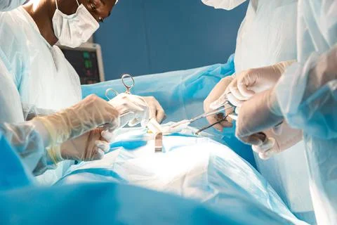 An international team of doctors performs a complex surgical operation on a Stock Photos