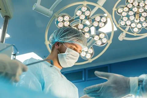 An international team of doctors performs a complex surgical operation on a Stock Photos