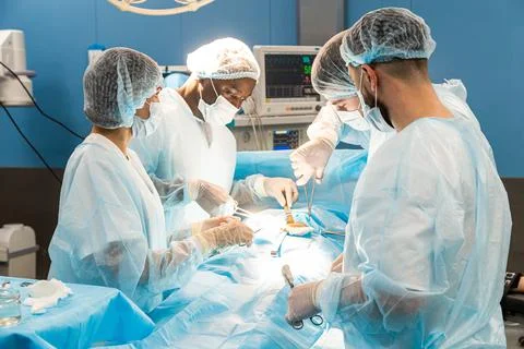 An international team of doctors performs a complex surgical operation on a Stock Photos