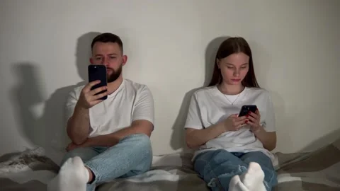 Internet addiction. Couple sitting separately in their phones without talk Video stock 250028106