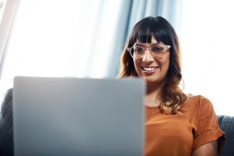 The internet allows you to turn hobbies into businesses. a young woman using her Stock Photos