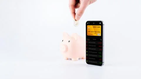Internet based banking. Mobile phone with internet online bank app. Piggy ban Stock Photos