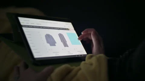 Internet browsing shopping at bed women's clothing Stock Footage 146038163