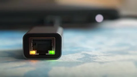 Internet cable adapter with yellow and green LED connected to laptop Stock Footage 280406781