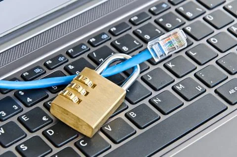 Internet cable and padlock on computer keyboard symbolizing data security Foto stock