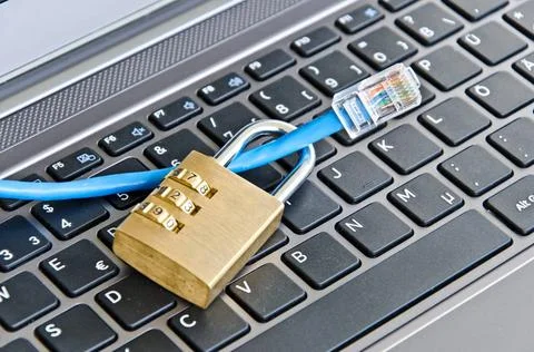 Internet cable and padlock on computer keyboard symbolizing data security ... Foto stock