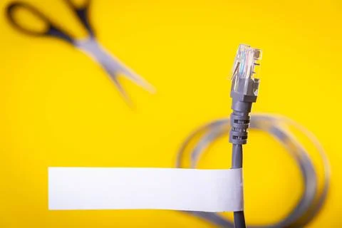 Internet cable and scissors cut it. Disconnection of Internet network. Conn.. Stock Photos