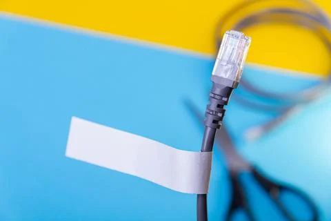 Internet cable and scissors cut it. Disconnection of Internet network. Conn.. Stock Photos