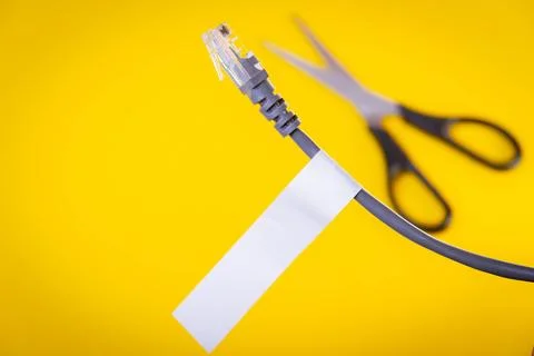Internet cable and scissors cut it. Disconnection of Internet network. Stock Photos