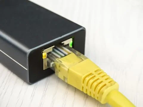 Internet cable connected to a multi-functional USB-C Hub station, Ethernet Stock Photos