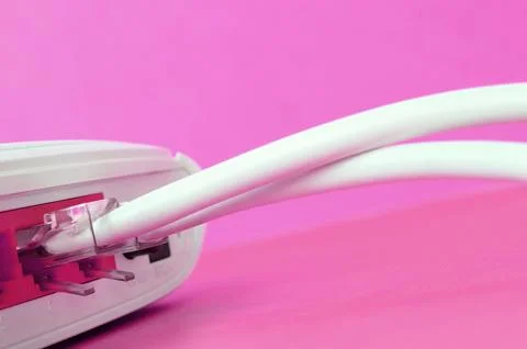 The Internet cable plugs are connected to the Internet router, which lies o.. Stock Photos