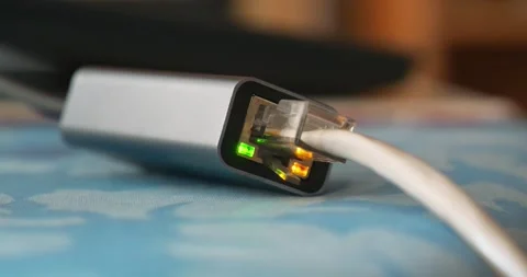 Internet cable through an adapter connected to laptop. Ethernet cable adapter Stock Footage 276921810