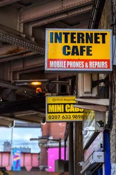 Internet Cafe and Mini Cabs signs on side of building Stock Photos