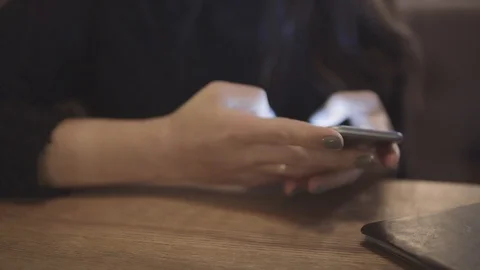 Internet, communication and technology concept - woman with cell phone in cafe Stock Footage 87917213